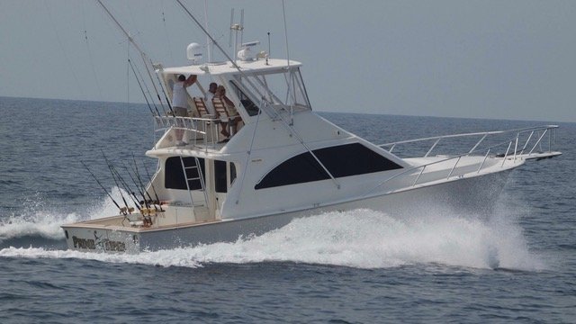 45' ocean yacht with many fishing poles cruising on the ocean